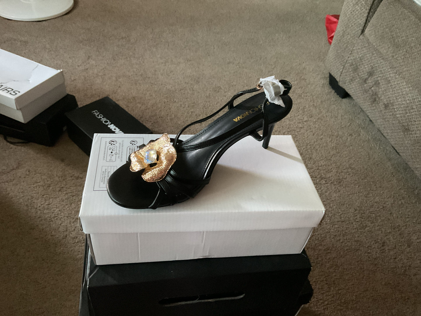 Black high heels with straps and gold flower